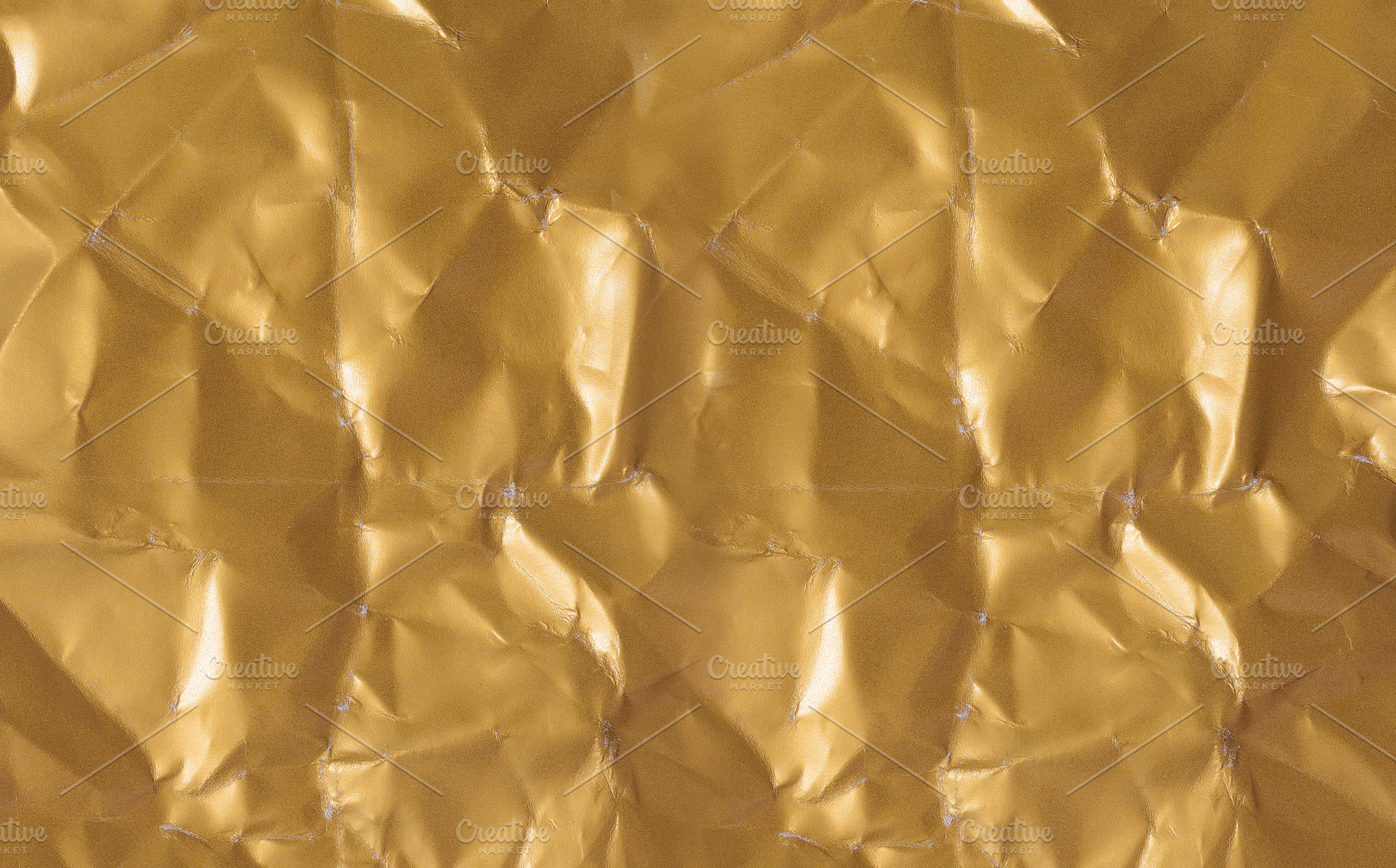Seamless texture of crumpled golden paper with shiny folds, a Photo by ndanko