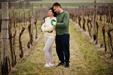 Couple working on vineyard in early spring., a Person Photo by AS photostudio