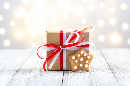 Gingerbread star and box of gift on bokeh lights background, a Holiday Photo by dashtik