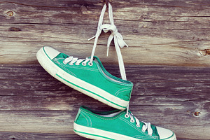 Old sneakers on wooden wall, a Sports & Recreation Photo by BOOCYS