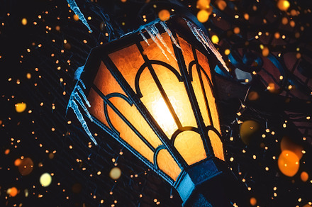 A magical old street lantern shines containing old, metal, and street