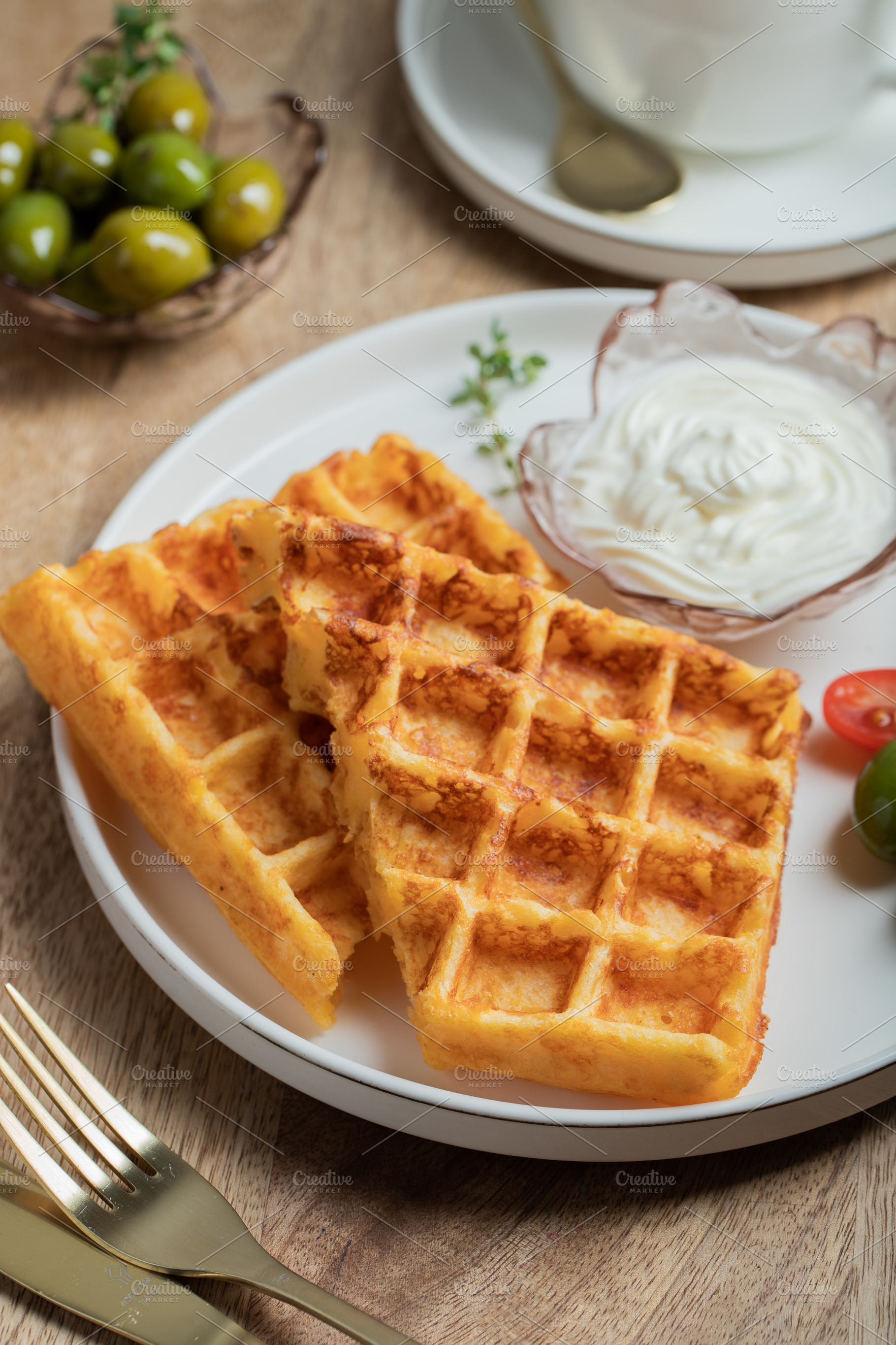 Crunchy waffle fries with sour cream dip served in a basket, a Food & Drink Photo by Budarinphoto