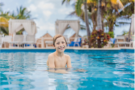 A young boy joyfully swims in a, a Sports & Recreation Photo by Elizaveta Galitskaya