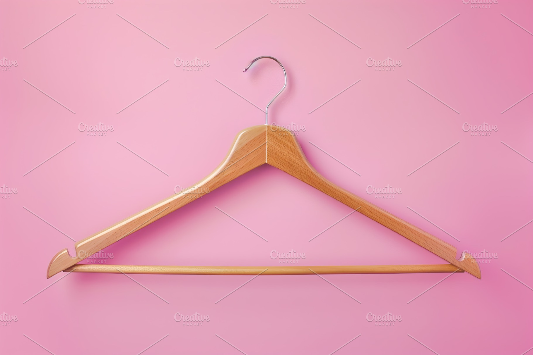 Wooden hanger on pink background, a Photo by AlyaAnd