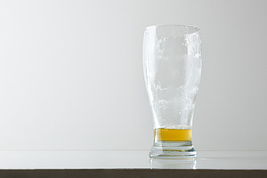 Empty and dirty beer glass with foam isolated on table, a Food & Drink Photo by Davizro's Market