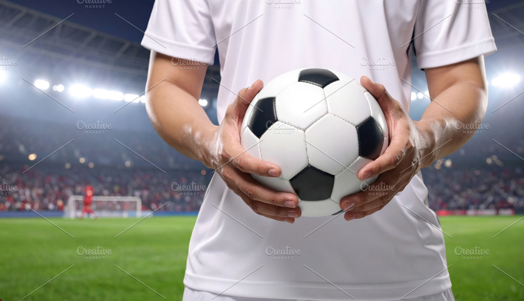 Soccer player holding ball in stadium lights, a Sports & Recreation Photo by Davizro's Market