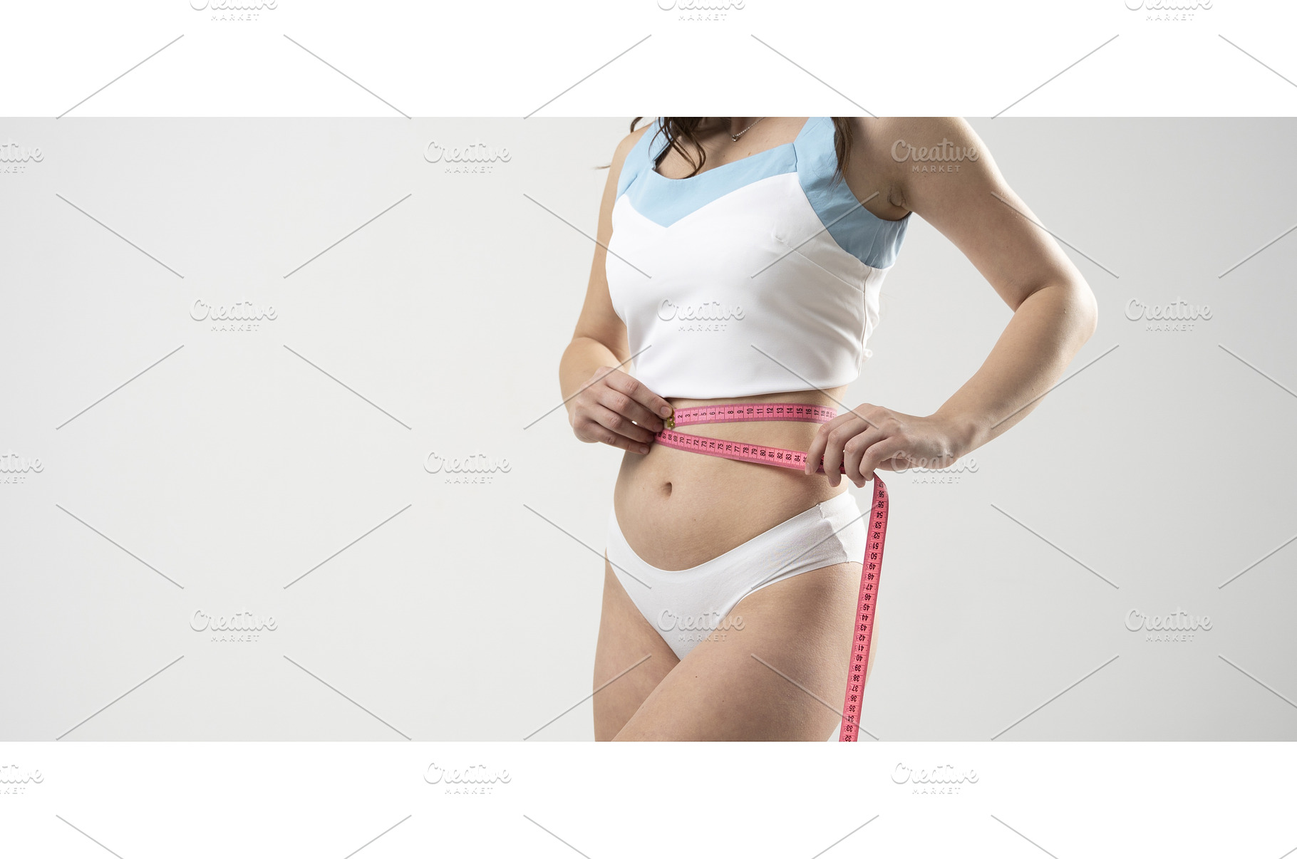 Slim young woman measuring waist, a Sports & Recreation Photo by volodymyrshtun13795