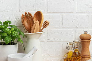 Kitchen utensils, fresh basil and mortar with pestle creating a, a Food & Drink Photo by Olena Rudo