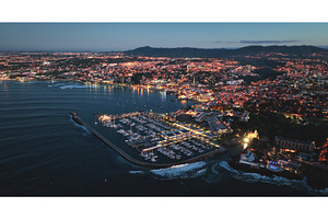 Cascais glowing at dusk, aerial view, an Architecture Photo by Goinyk