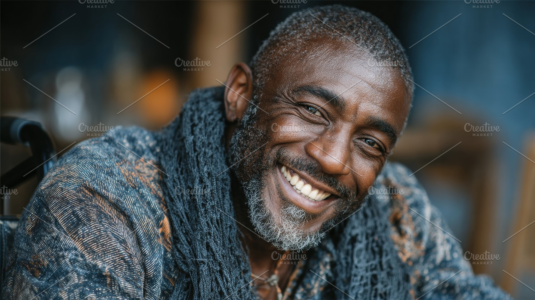 Smiling black man with gray hair and scarf sitting outdoors, a Photo by AS photostudio