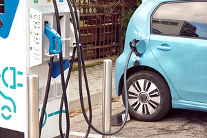 Electric car at charging station, a Transportation Photo by BOOCYS