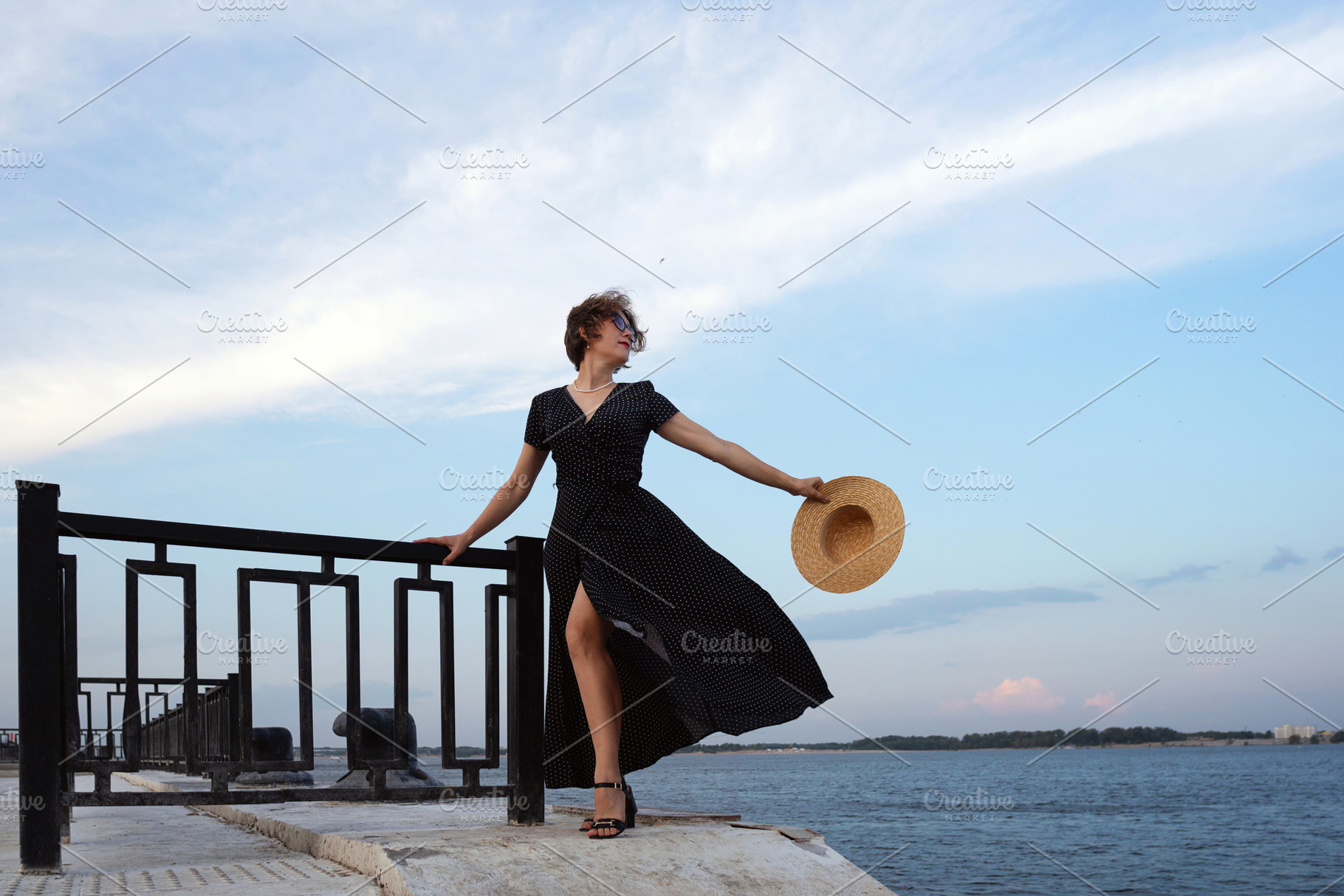 Woman holds straw hat while posing, a Person Photo by Elena Vagengeim