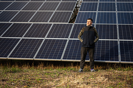 Man on the background of solar panels.  Eco energy., a Technology Photo by AS photostudio