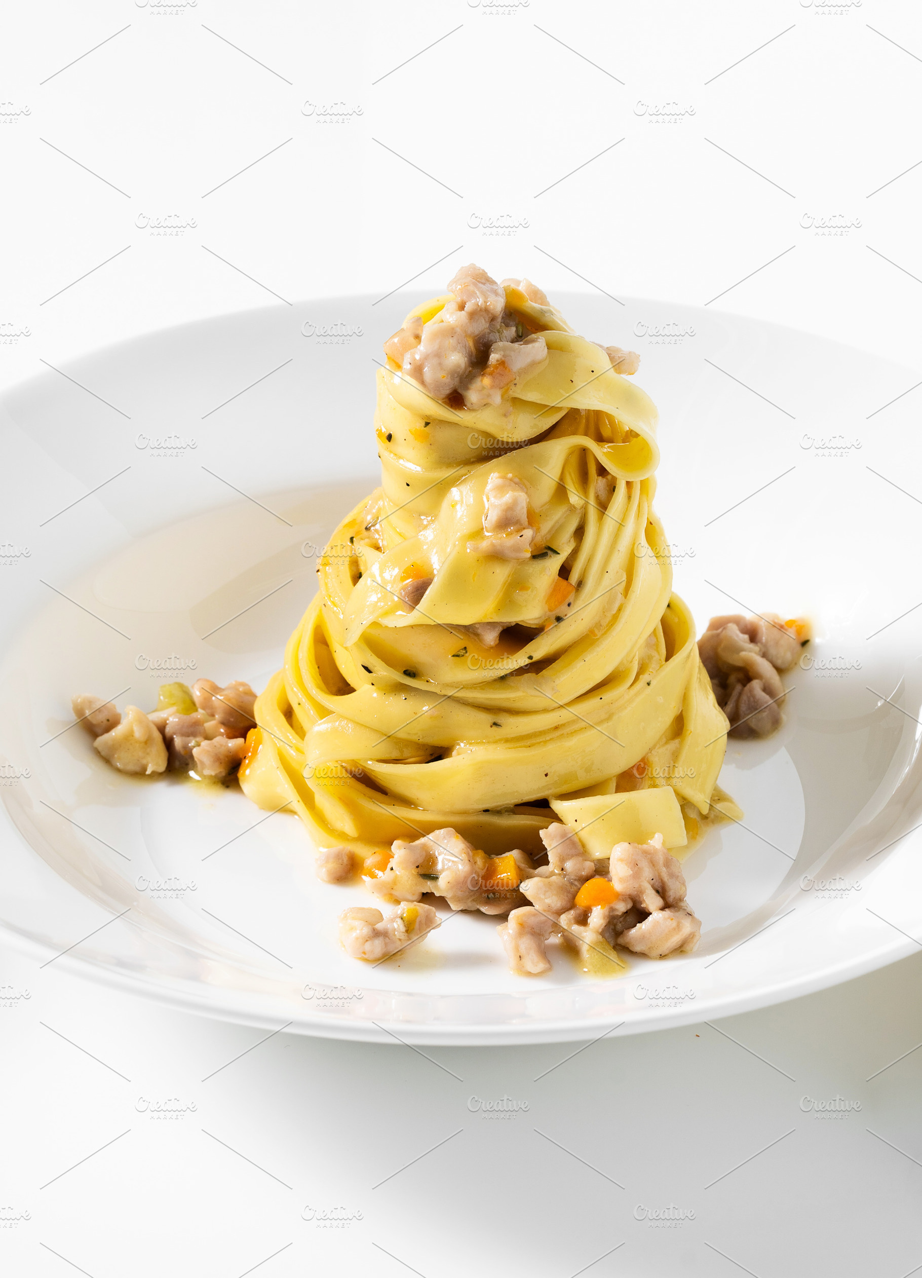 pasta tagliatelle with rabbit sauce on the white table. menu for, a Food & Drink Photo by IriGri