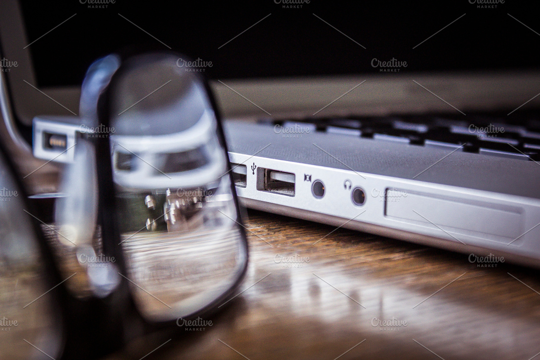 Glasses Next To A Macbook Pro