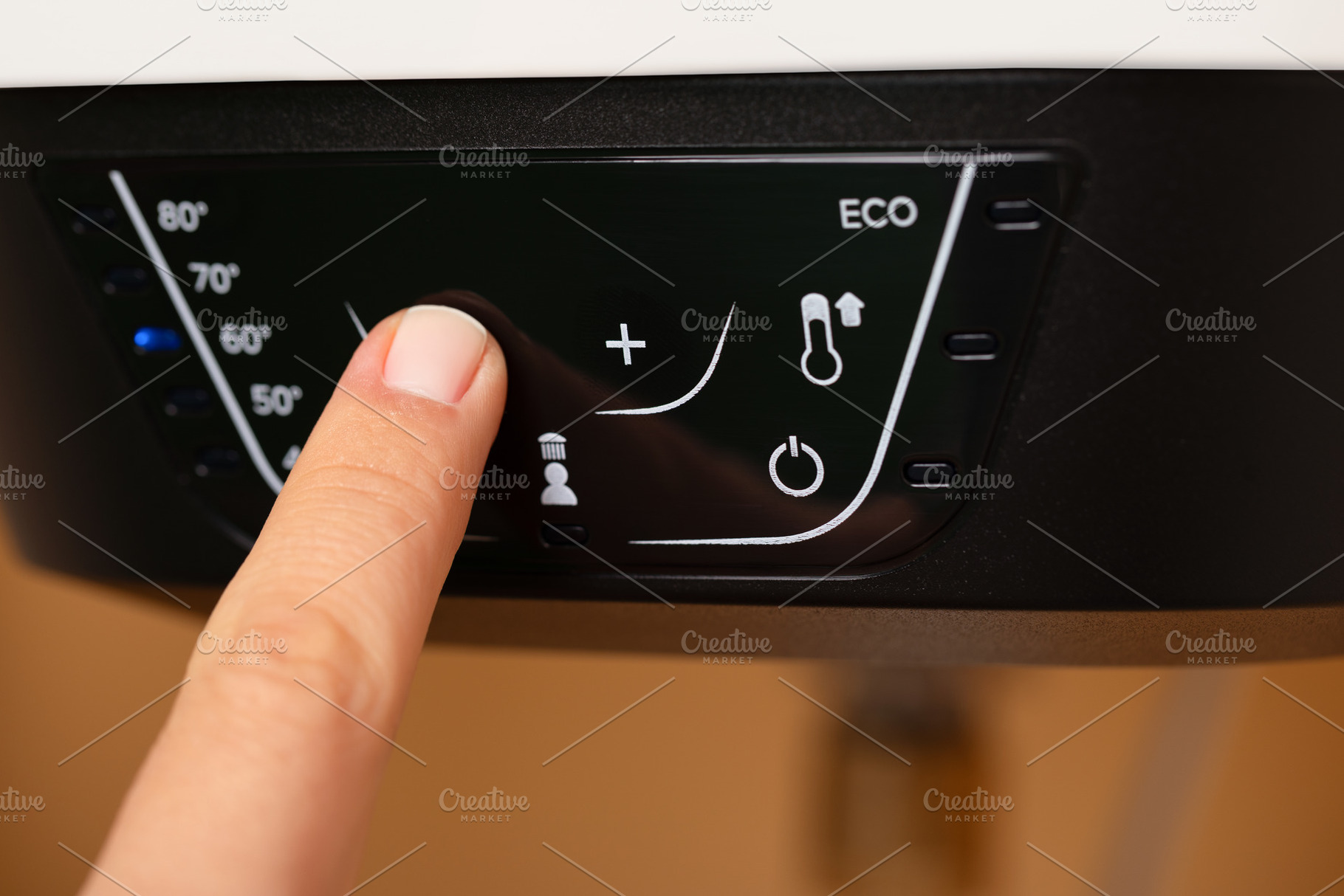 Hand Adjusting Water Heater Temperature, a Technology Photo by Ales Munt