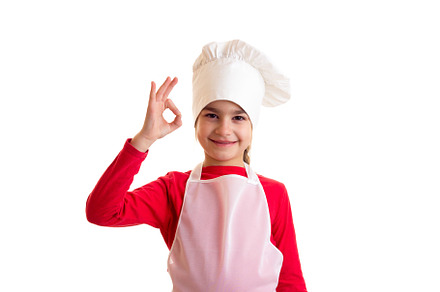 Little girl cooking containing action, apron, and baker