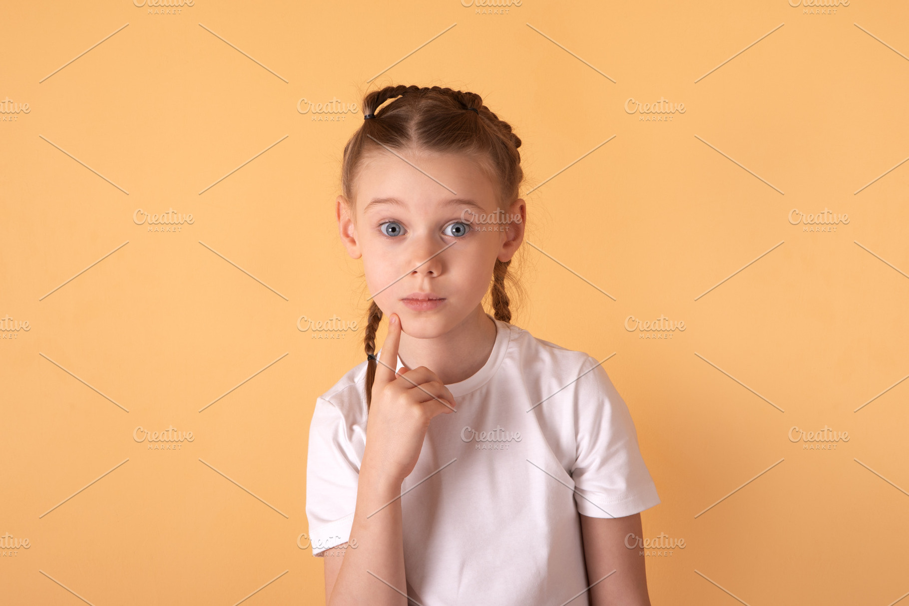 Portrait of a young girl with braids in a white t-shirt, looking, a Person Photo by Ales Munt