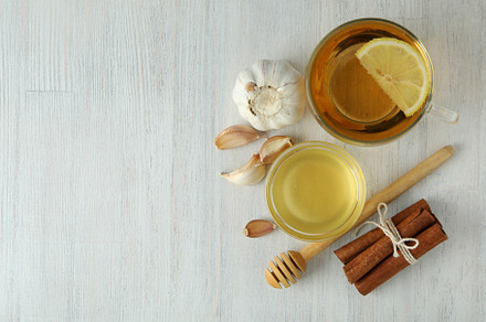 Concept of treatment colds with honey and garlic on white wooden, a Health & Medical Photo by AtlasStudio PRO