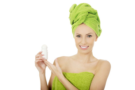 Young woman holding deodorant.