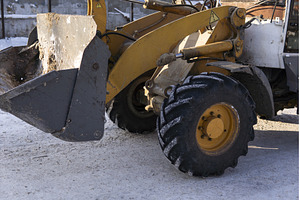 Yellow wheel loader working on, an Industrial Photo by volodymyrshtun13795