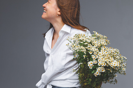 Girl with daisies in studio