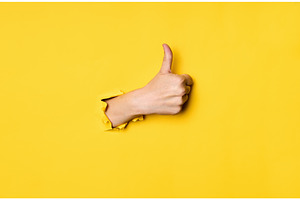 Thumb up hand gesture through hole, a Business Photo by Gladkov photography
