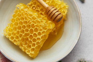 Honeycomb resting in bowl with honey dipper and fresh mint, a Food & Drink Photo by Olena Rudo