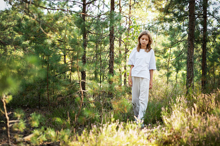 A child exploring a serene forest trail on a sunny day, surround, a Person Photo by Olena Rudo