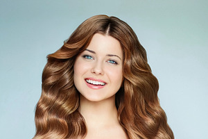 Beautiful young woman with long wavy brown hair smiling, feeling, a Person Photo by Studio ANNA