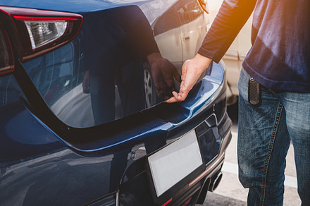 Closeup of man hand opening hatchback trunk by touching sensor d, a Transportation Photo by Ministocker