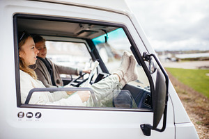 Friends driving in camper van containing outdoor, sport, and active