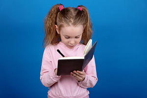 Child Writing in Notebook, a Person Photo by Ales Munt