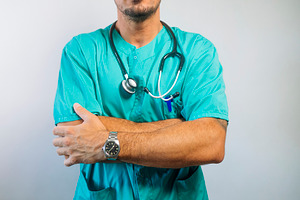 Close-Up of Doctor with Arms Crossed, a Person Photo by karrastock
