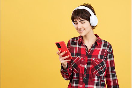 Androgynous person listening to, a Person Photo by Iván Moreno STOCK PHOTO