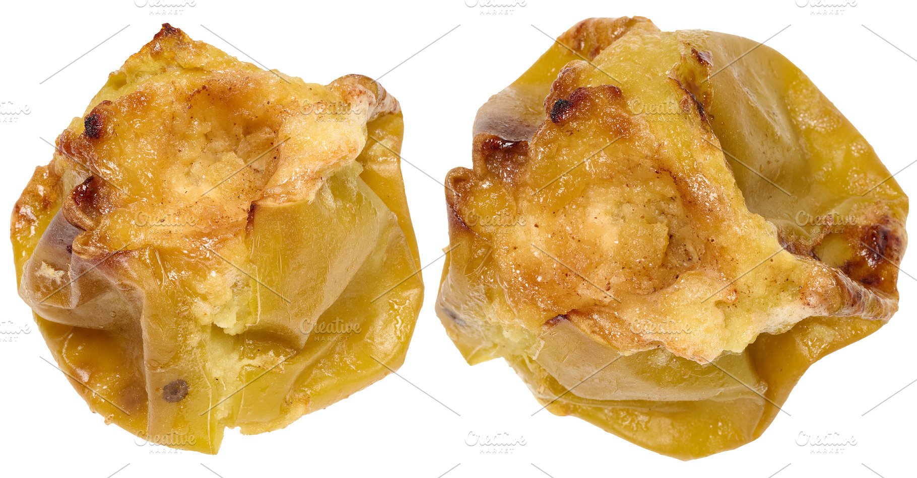 Two whole baked green apples with soft, wrinkled skin. Isolated, a Food & Drink Photo by ndanko
