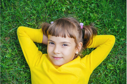The child lies on the grass, a Person Photo by yanadjana