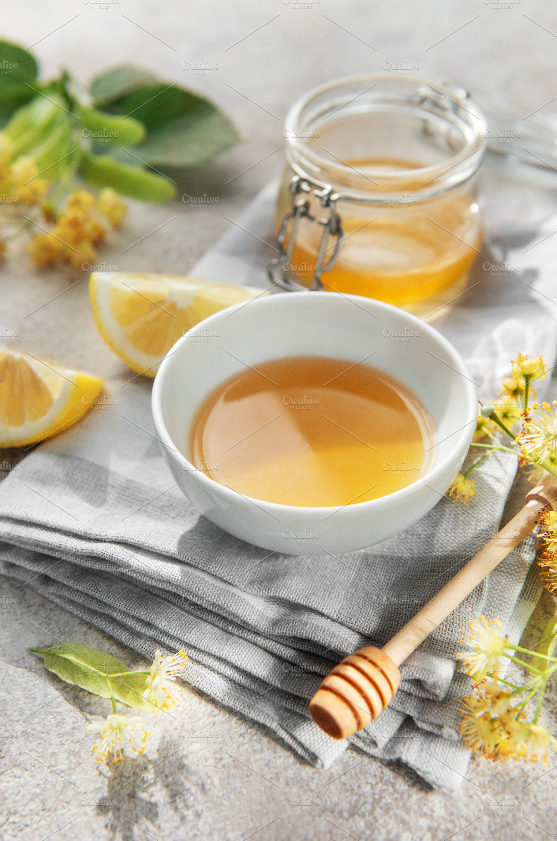 Natural linden honey in bowl with fresh lemon, a Food & Drink Photo by Olena Rudo
