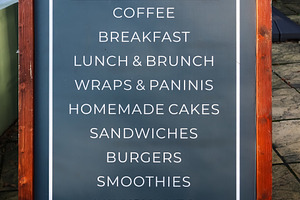 Cafe menu board listing coffee, breakfast, lunch, brunch, wraps,, a Photo by Studio ANNA