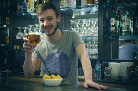 Waiter serving beer in the pub featuring waiter, barman, and pub