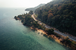Aerial view  road along the sea,Seaside road approaching a beach