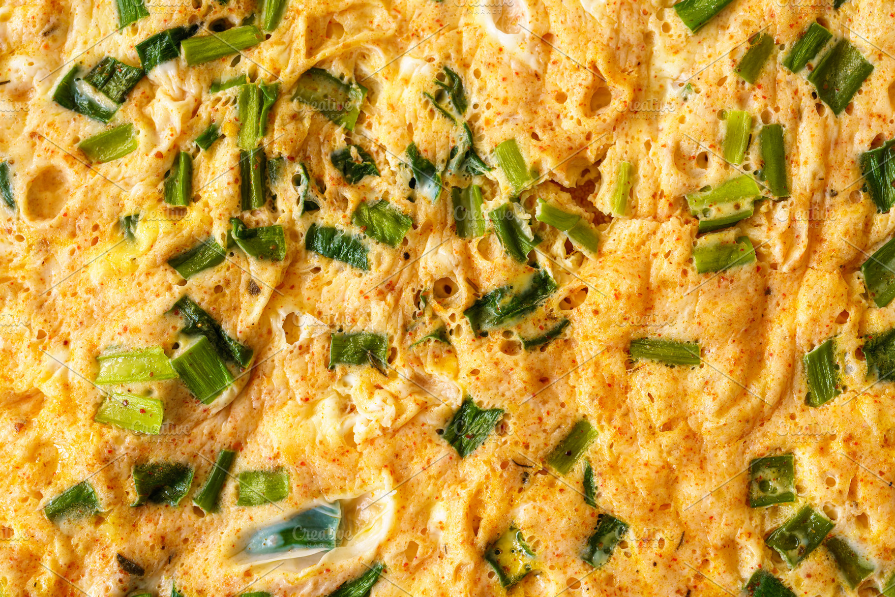 Macro shot capturing the texture of a homemade omelet cooked with fresh green o, a Food & Drink Photo by Eugene_Photo