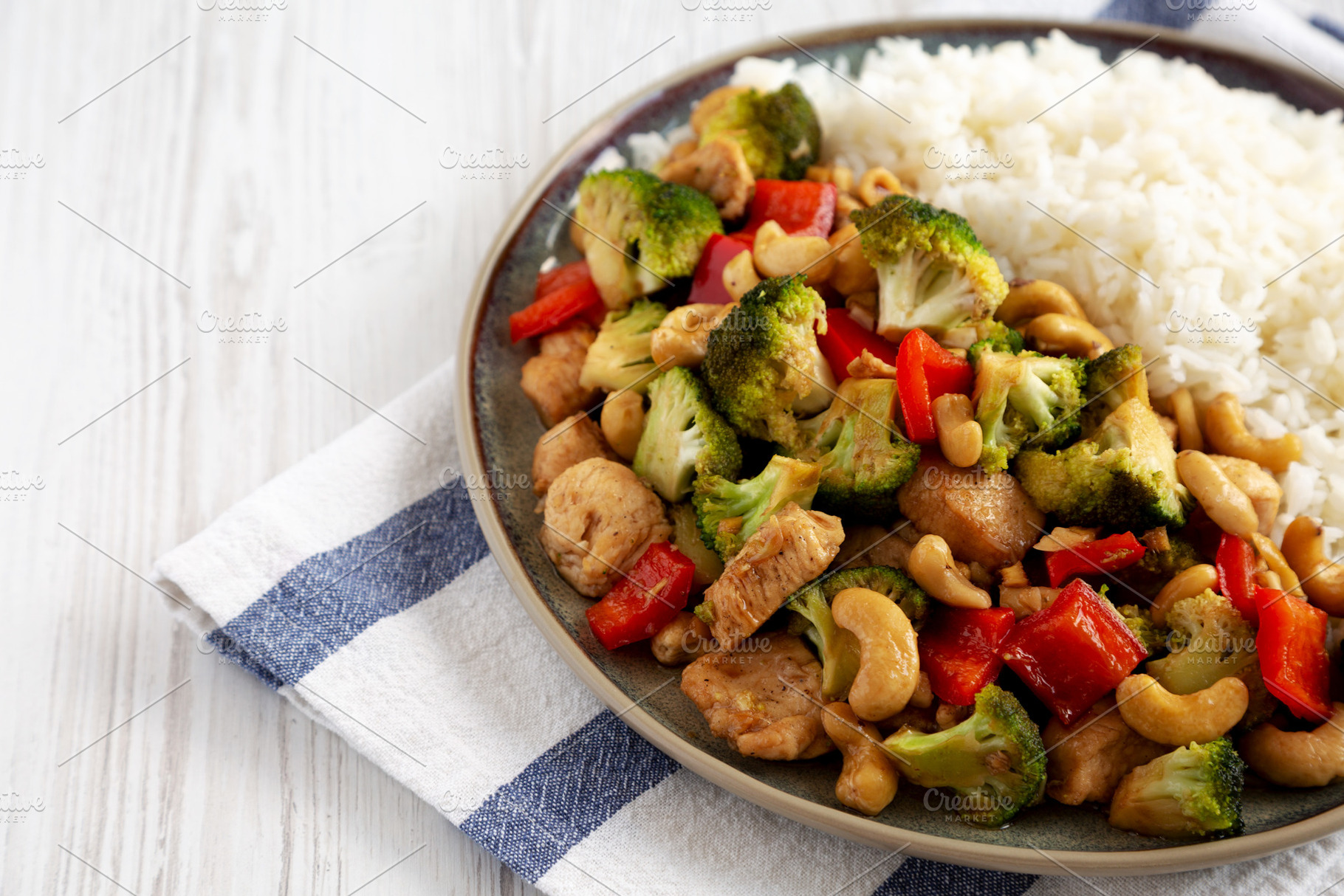 Homemade Cashew Chicken Stir-Fry on a Plate, side view. Copy spa, a Food & Drink Photo by LiudmylaChuhunova
