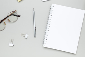 Calm and focused workspace featuring coffee cup, glasses, and notebook in minim