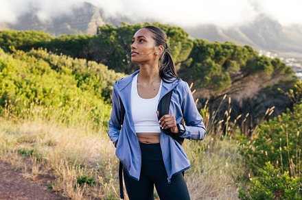 Woman hiker in sportswear looking