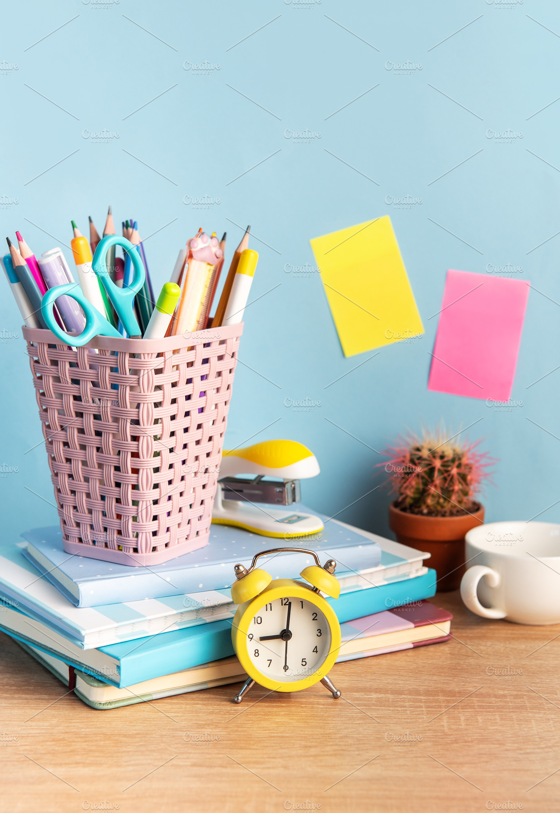 Student desk with school supplies and alarm clock, a School & Education Photo by Olena Rudo