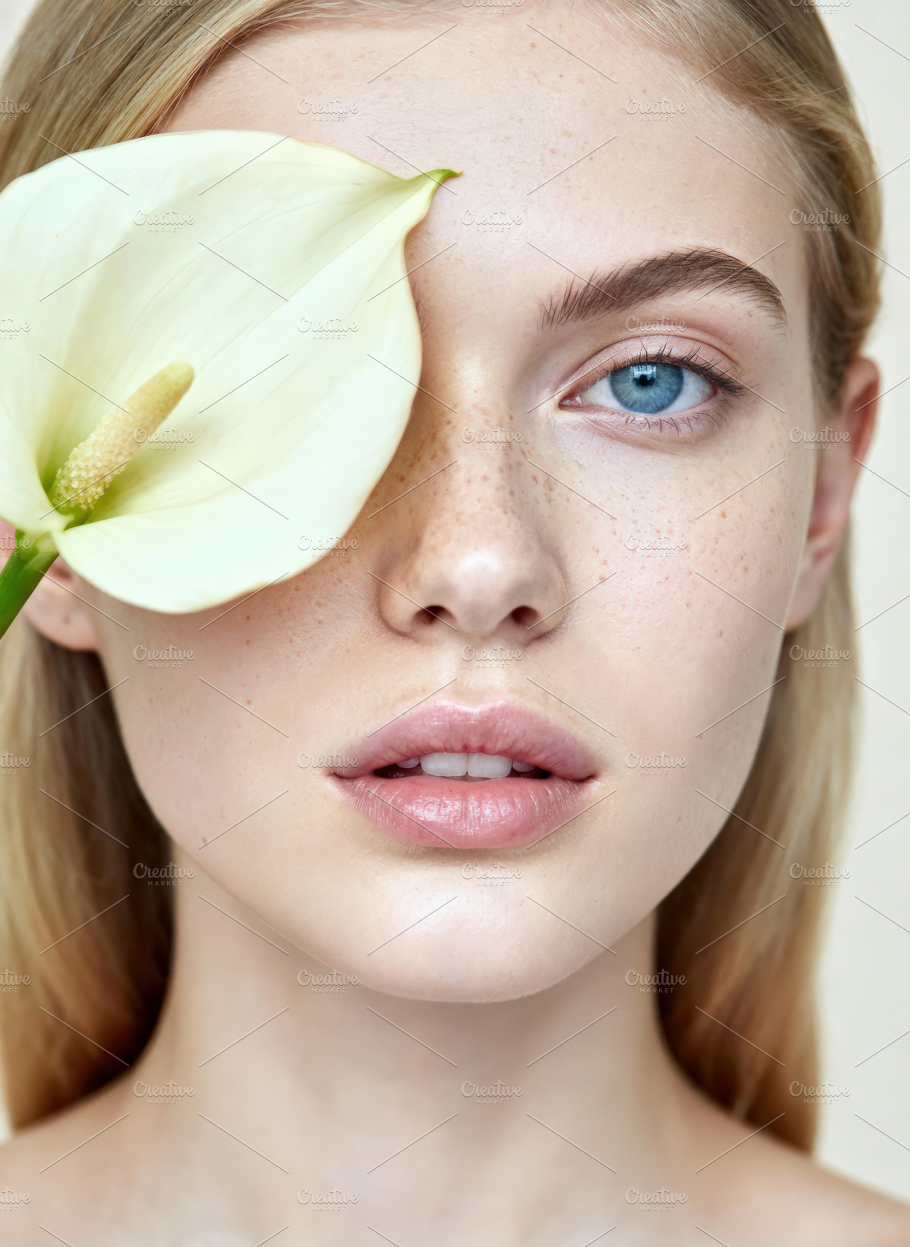 Woman with Calla Lily Covering Eye, a Person Photo by Virgo Studio