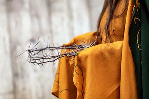 Woman holding crown of thorns, symbol of Jesus Christ's passion, a Holiday Photo by Antonio Gravante Market