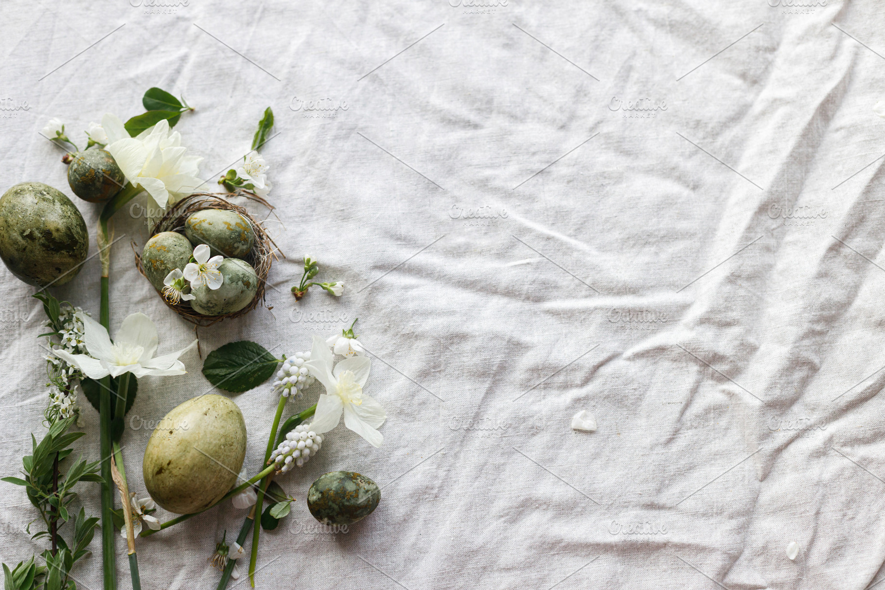 Easter flat lay. Stylish easter eggs in nest, daffodils flowers, a Holiday Photo by Sonjachni
