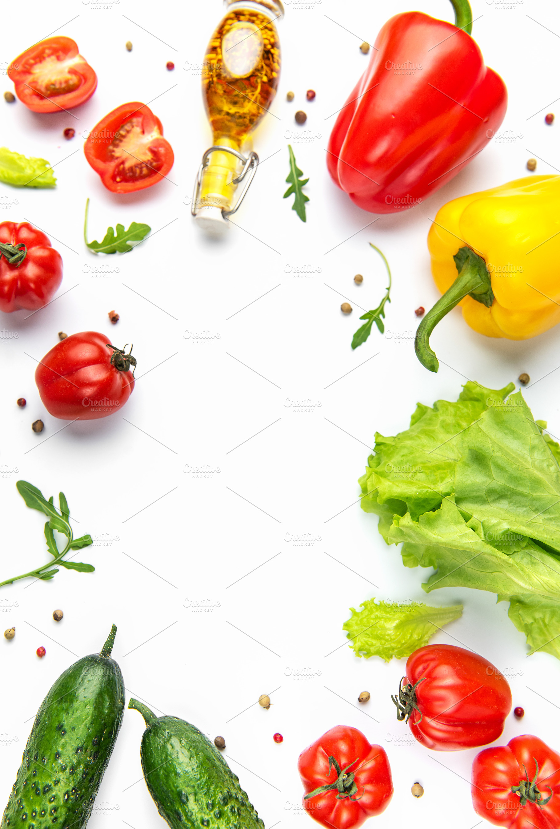 Fresh colorful vegetables and olive oil creating a healthy borde, a Food & Drink Photo by Olena Rudo
